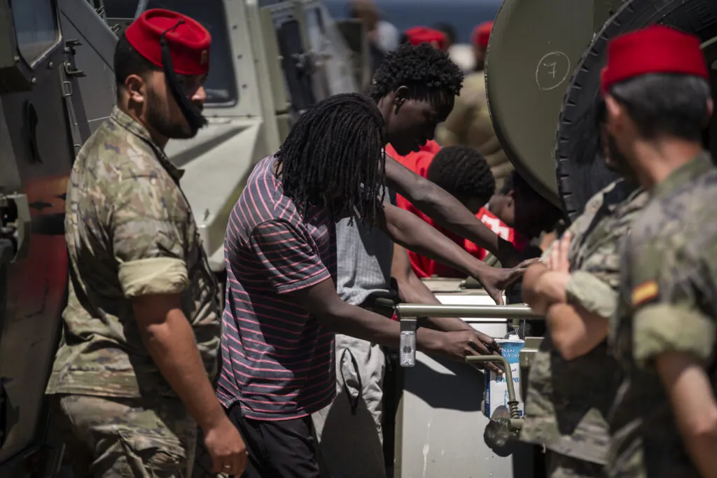 Migrants arrive outside the CETI reception centre in Ceuta